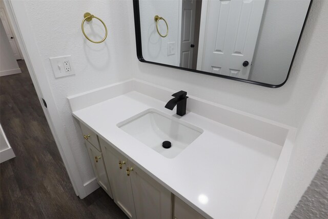 bathroom with vanity and hardwood / wood-style flooring