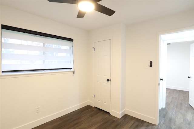 unfurnished bedroom featuring dark hardwood / wood-style flooring, a closet, and ceiling fan