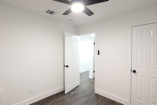 unfurnished bedroom with ceiling fan and dark hardwood / wood-style flooring