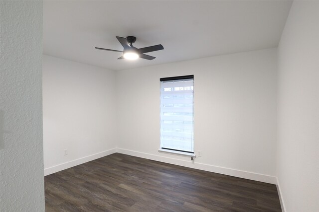 empty room featuring ceiling fan and dark hardwood / wood-style floors