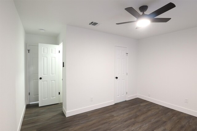 spare room featuring ceiling fan and dark hardwood / wood-style flooring