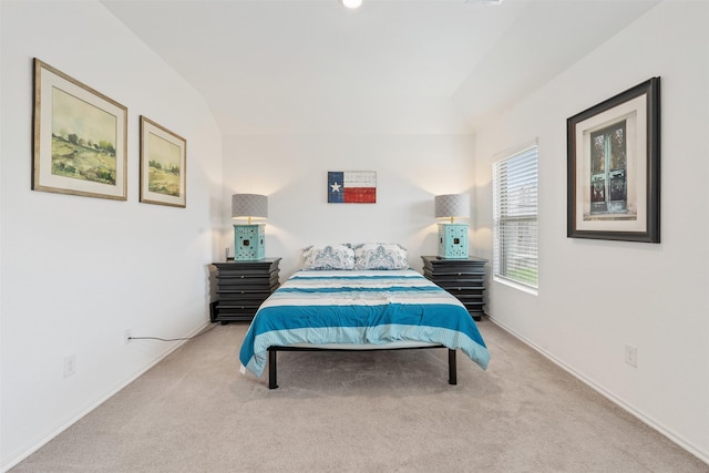 carpeted bedroom with lofted ceiling