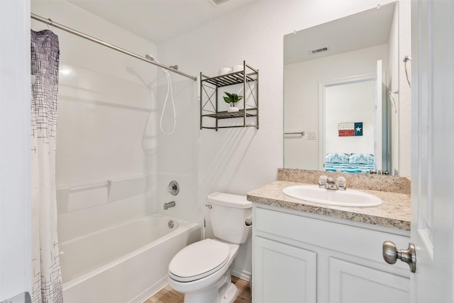 full bathroom featuring vanity, shower / bath combo with shower curtain, and toilet