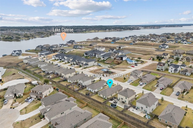 birds eye view of property with a water view and a residential view