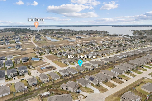 birds eye view of property featuring a water view and a residential view