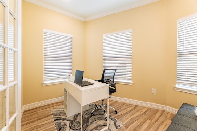 office area with light wood-type flooring and ornamental molding