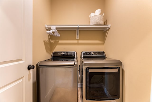 clothes washing area with washer and dryer