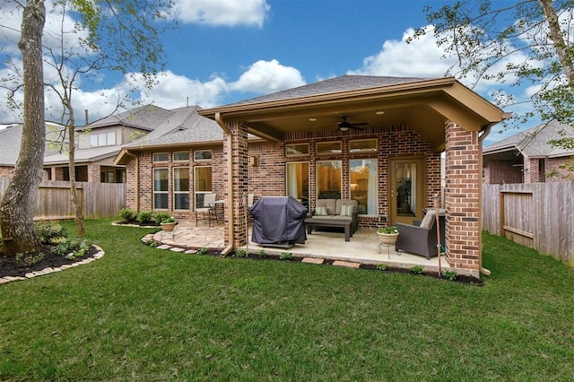 rear view of property featuring an outdoor hangout area, a patio area, ceiling fan, and a yard