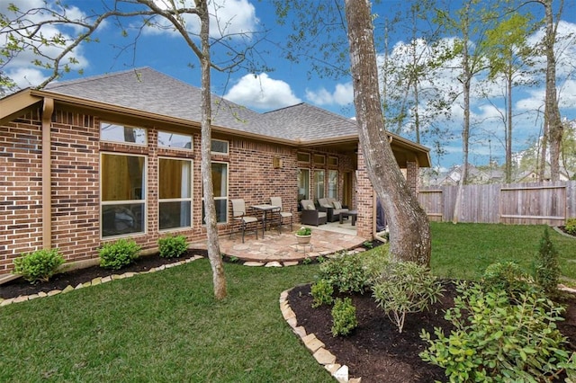 rear view of property featuring a yard, an outdoor hangout area, and a patio