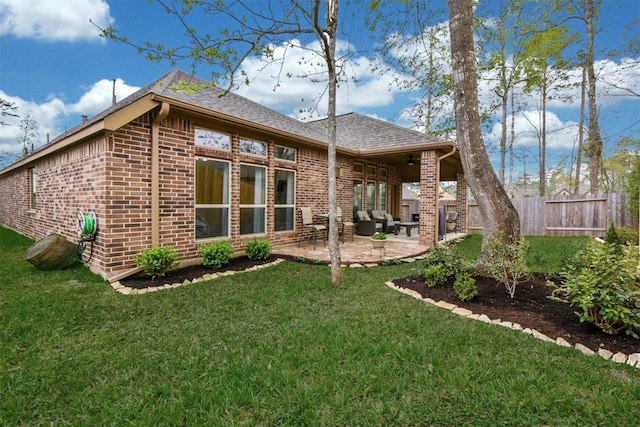 rear view of house featuring a patio and a lawn