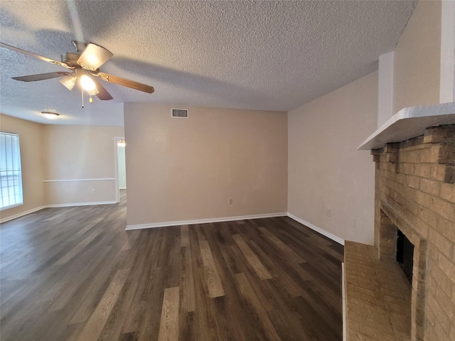 unfurnished living room featuring a ceiling fan, a brick fireplace, baseboards, and dark wood-style flooring