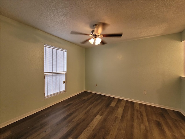 empty room with dark wood-style floors, baseboards, and a ceiling fan