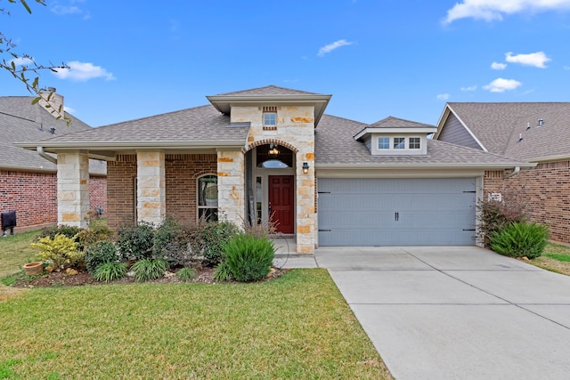 view of front of house with a garage and a front lawn