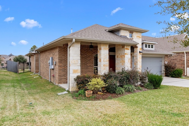 view of front of property featuring a front yard and a garage