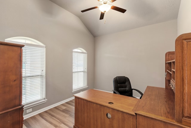 office space featuring lofted ceiling, light wood-type flooring, and ceiling fan