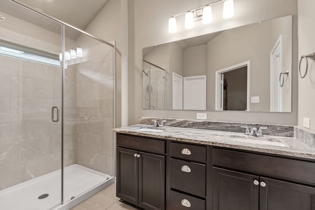 bathroom with vanity, an enclosed shower, and tile patterned flooring