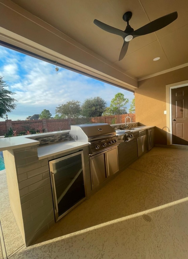 view of patio / terrace with a grill, sink, and an outdoor kitchen