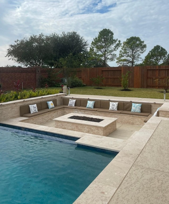 view of pool with an outdoor fire pit