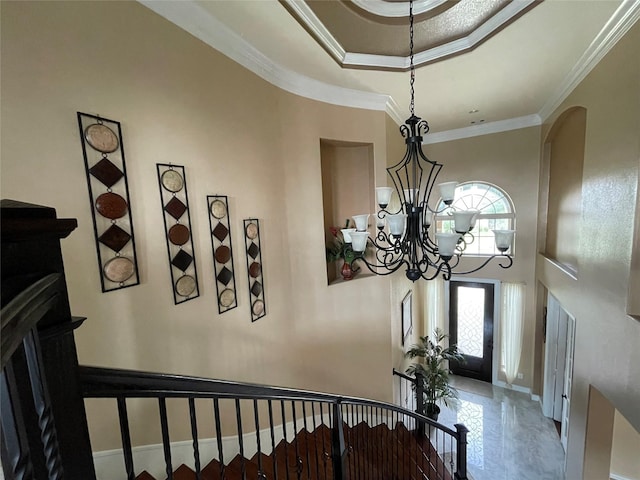 foyer entrance with a notable chandelier and ornamental molding