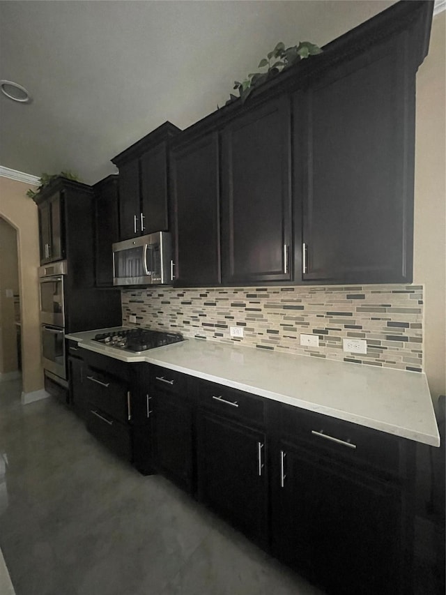 kitchen featuring ornamental molding, stainless steel appliances, and decorative backsplash