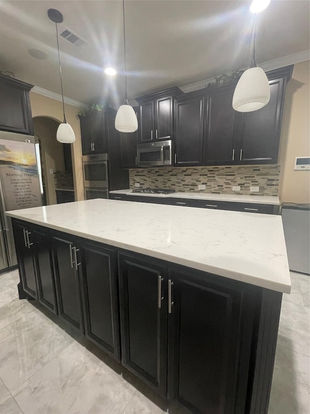 kitchen with ornamental molding, stainless steel appliances, a center island, and hanging light fixtures