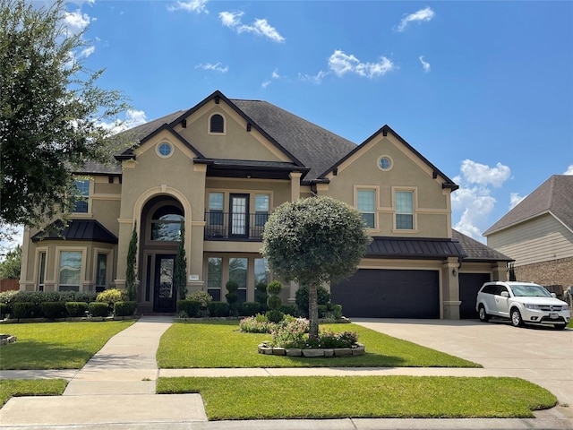 view of front of house featuring a garage and a front lawn