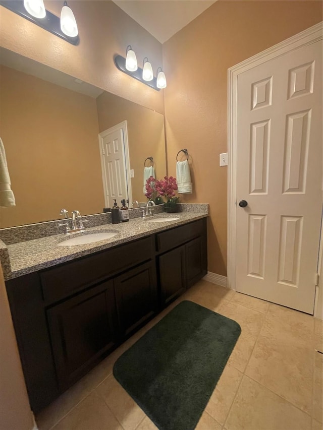 bathroom with tile patterned flooring and vanity