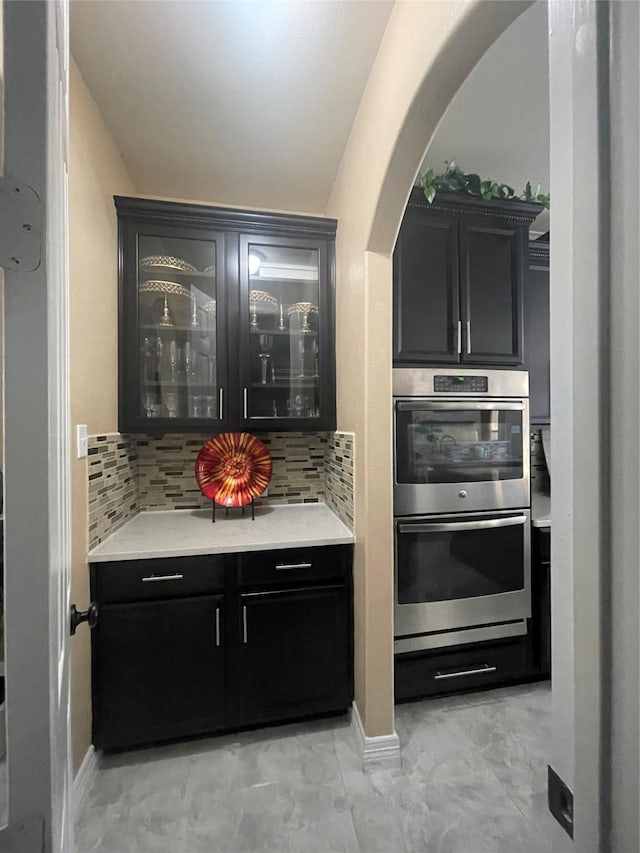 kitchen with tasteful backsplash and double oven