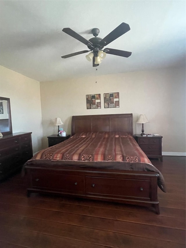 bedroom with dark hardwood / wood-style floors and ceiling fan