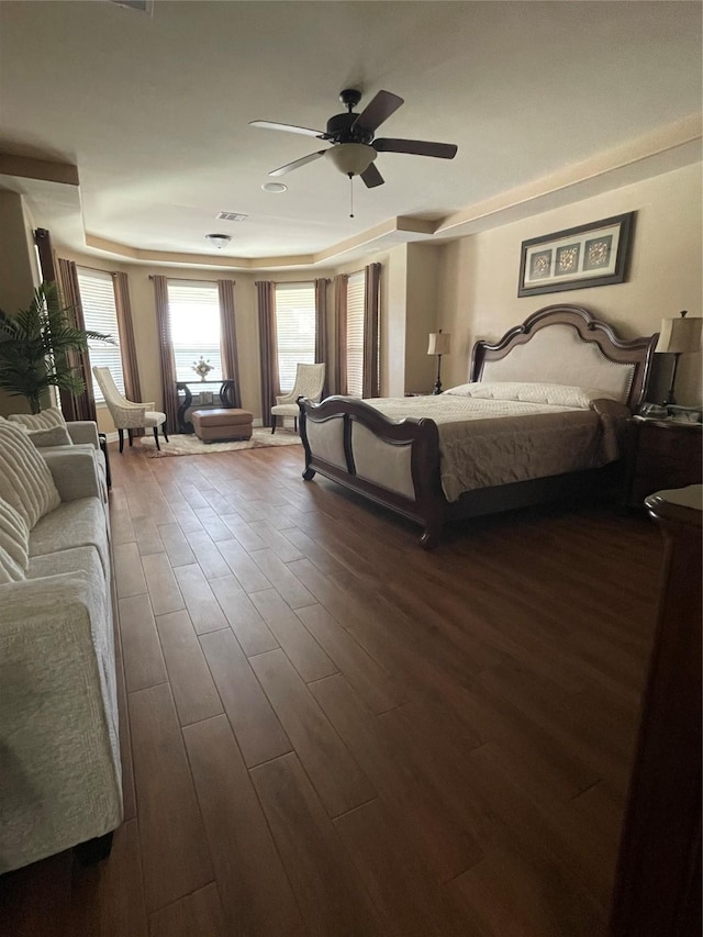 bedroom with dark hardwood / wood-style floors and ceiling fan