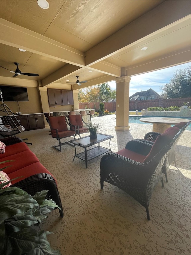 view of patio featuring a fenced in pool and ceiling fan