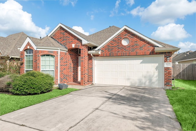 view of front property featuring a front yard and a garage