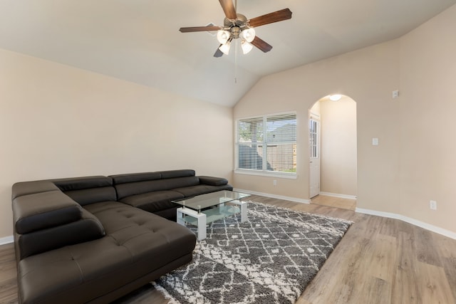 living room featuring ceiling fan, hardwood / wood-style floors, and lofted ceiling