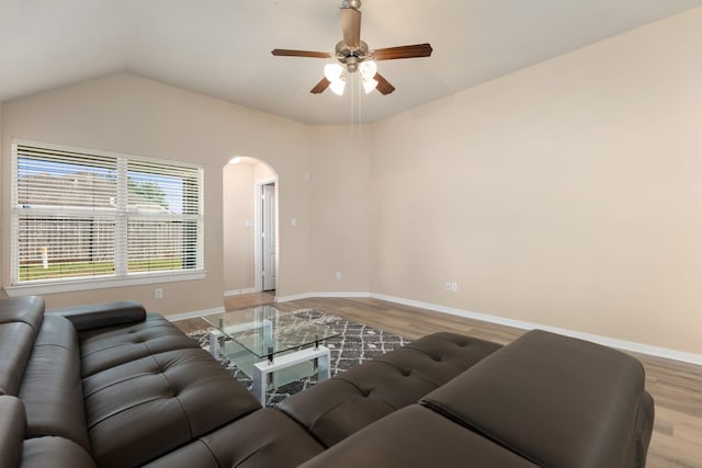 living room featuring ceiling fan, vaulted ceiling, and hardwood / wood-style flooring