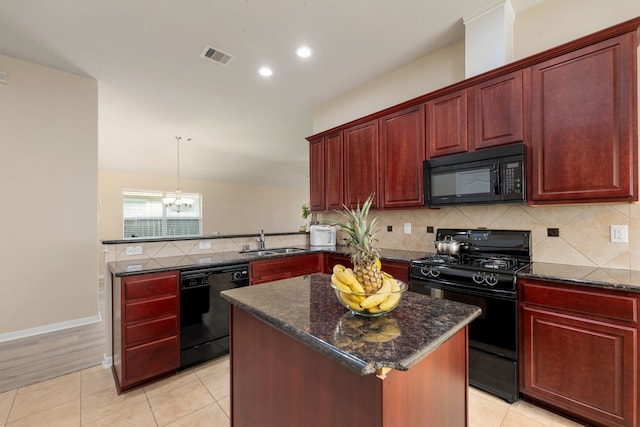 kitchen with black appliances, a center island, kitchen peninsula, sink, and light tile patterned flooring