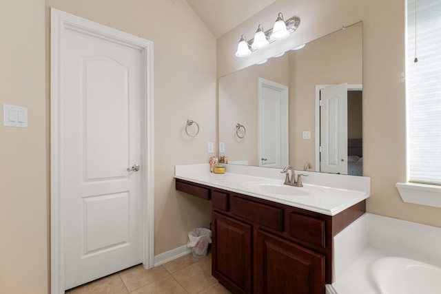 bathroom with vanity, tile patterned flooring, a tub to relax in, and vaulted ceiling