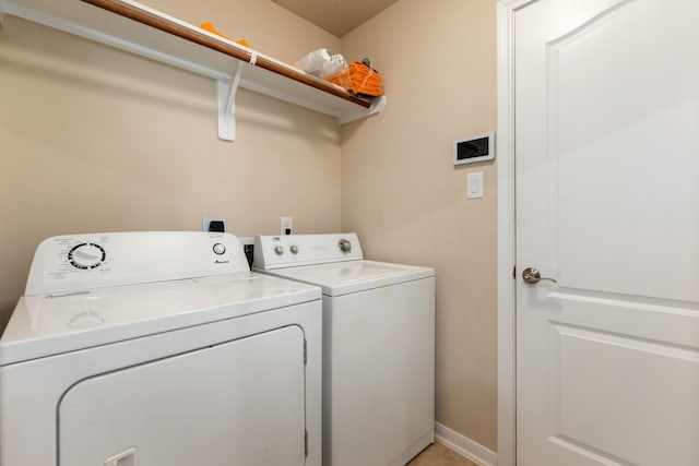 clothes washing area featuring washer and dryer