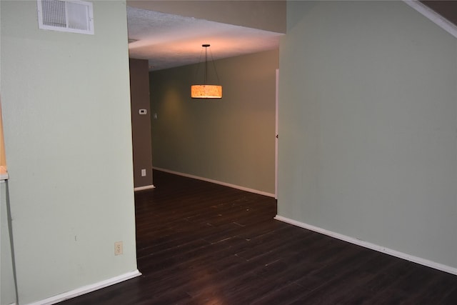 spare room with dark hardwood / wood-style flooring