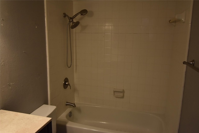 bathroom with tiled shower / bath and toilet