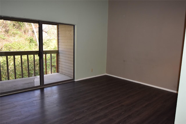 unfurnished room with dark wood-type flooring and a wealth of natural light