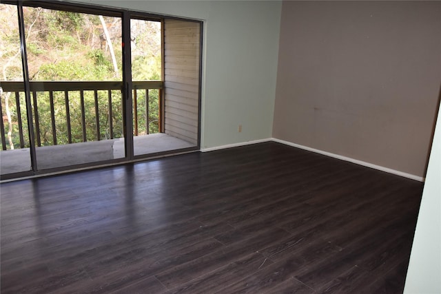 unfurnished room featuring dark hardwood / wood-style floors and plenty of natural light