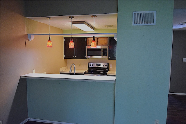 kitchen with sink, stainless steel appliances, and hanging light fixtures