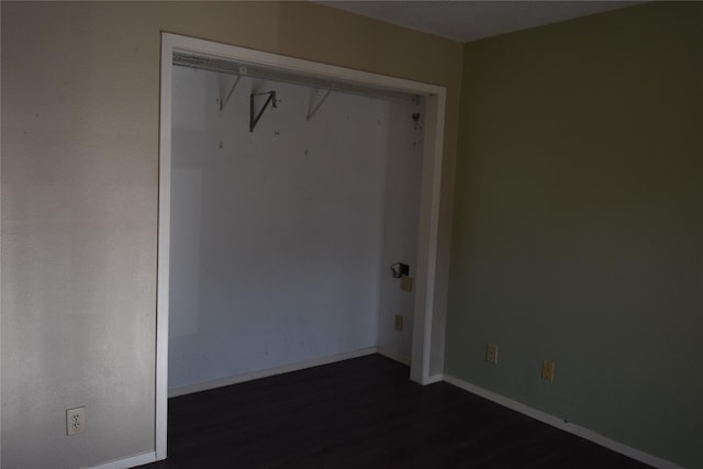 unfurnished room featuring dark wood-type flooring