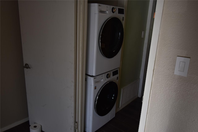 laundry room with stacked washer and dryer