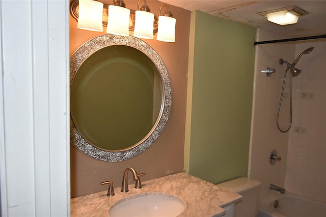 full bathroom with vanity, tiled shower / bath combo, and toilet