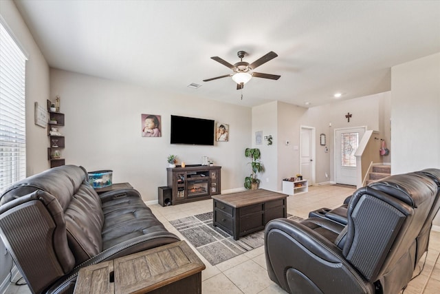 tiled living room with ceiling fan