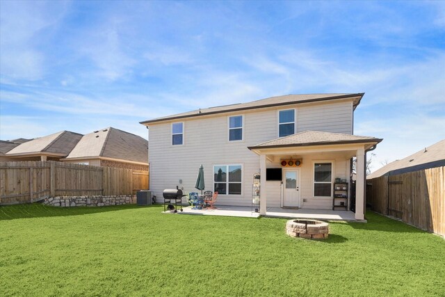 back of house featuring an outdoor fire pit, cooling unit, a yard, and a patio