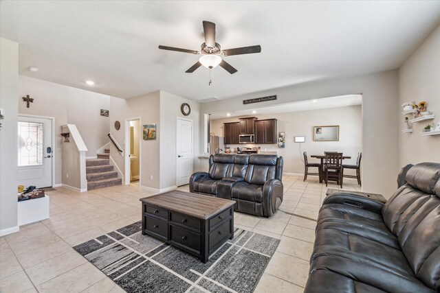 tiled living room with ceiling fan