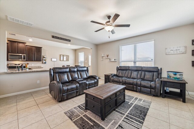 tiled living room with ceiling fan