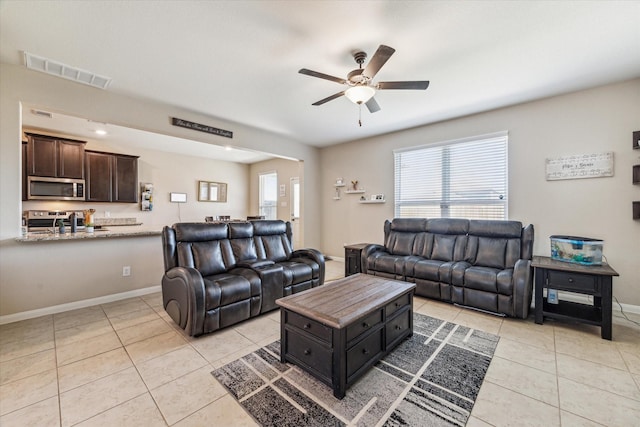 tiled living room featuring ceiling fan